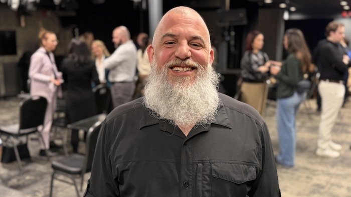 FrÃ©dÃ©ric Arsenault poses for the photo, smiling. 