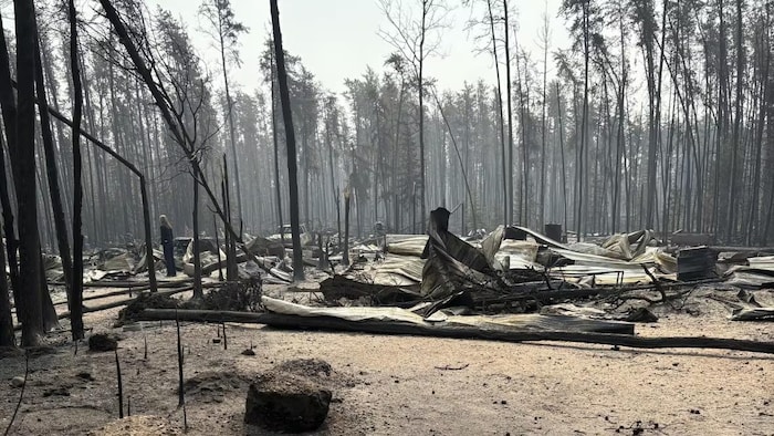 Ruins and smoke after the passage of an East Trout Lake fire. state emergency lifted saskatchewan after