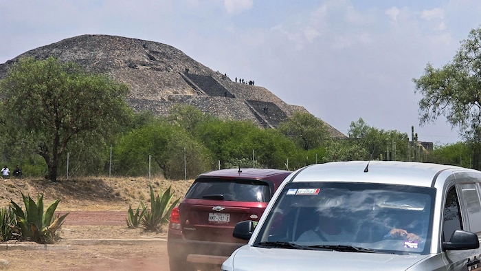 Des voitures devant une pyramide.
