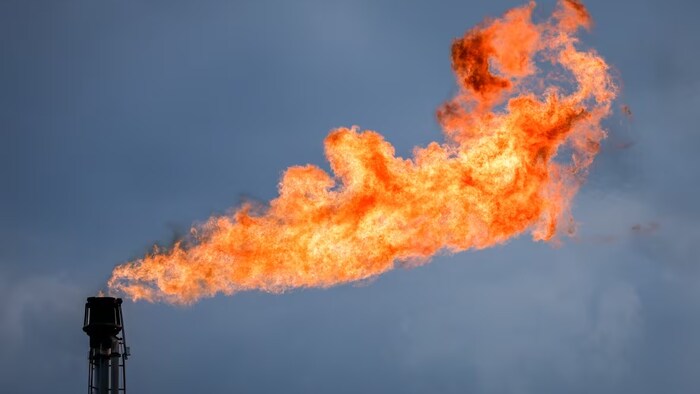 A flare stack burns off excess gas at a processing facility near Crossfield, Alta., on June 13. Advocates say Canada and other rich countries are not doing enough to curb emissions. (Jeff McIntosh/The Canadian Press)