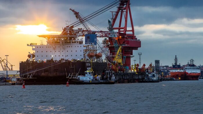 Tugboats get into position on the Russian pipe-laying vessel "Fortuna" in the port of Wismar, Germany, on Jan 14, 2021. The special vessel was being used for construction work on the German-Russian Nord Stream 2 gas pipeline in the Baltic Sea. (Jens Buettner/AP)