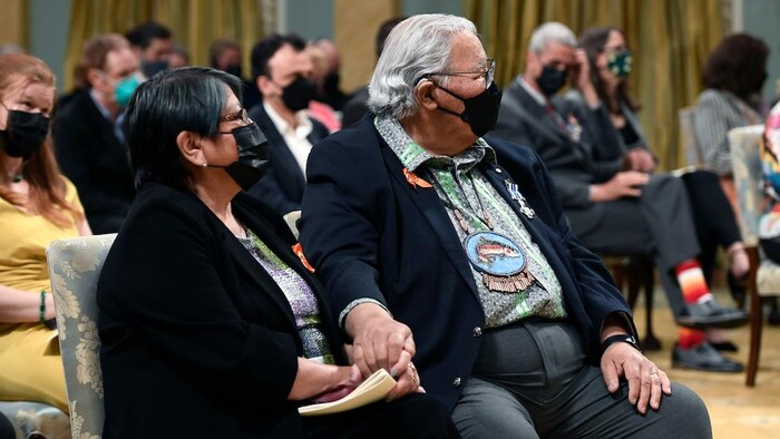 Katherine Morrisseau-Sinclair holds the hand of her husband, Murray Sinclair, at Thursday's ceremony.