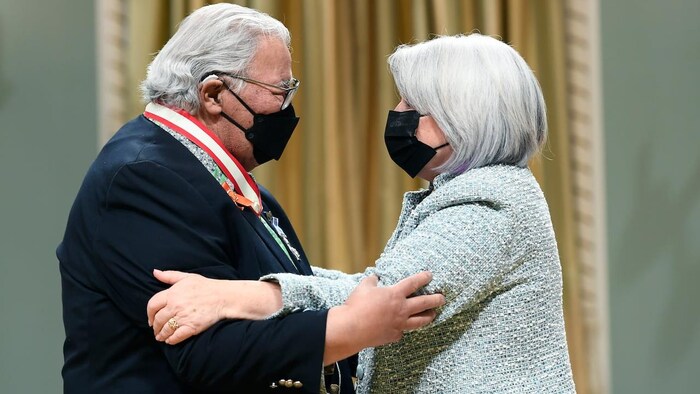 Murray Sinclair is embraced by Gov. Gen. Mary Simon after being invested as a companion of the Order of Canada. 