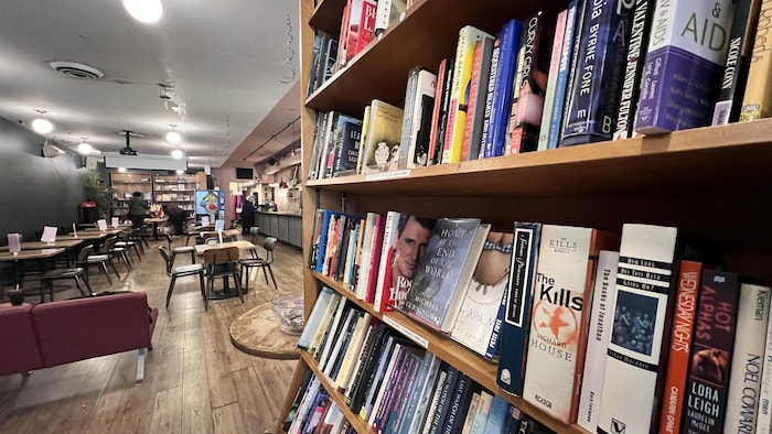 Une étagère de livres et des tables à la librairie Glad Day.