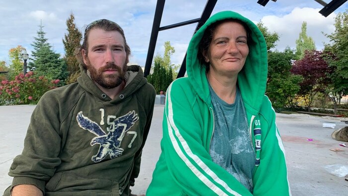 Portrait of a man and a woman sitting in a park.