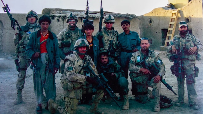Wardak (front row, middle) worked as an interpreter in 2007 and 2008 with Canadian troops who were mentoring Afghan soldiers and police in Kandahar Province. 