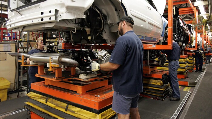 Des travailleurs procèdent à l'assemblage d'un véhicule à l'usine de GM à Ingersoll.