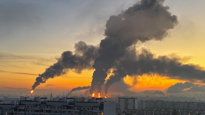 De la fumée et du feu s'élèvent d'un immeuble endommagé après une attaque.
