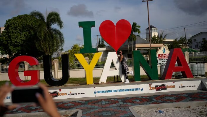 A woman poses for photos in Georgetown, Guyana, on April 12, 2023. Guyana, which has one of the world’s highest emigration rates with more than 55% of the population living abroad, now claims one of the world’s largest shares of oil per capita and is expected to have one of the world’s fastest-growing economies, according to a World Bank report. (Matias Delacroix/The Associated Press)