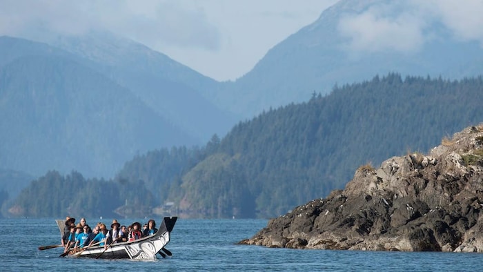 Des visiteurs naviguent en canoë dans l’archipel Haida Gwaii, en Colombie-Britannique. 