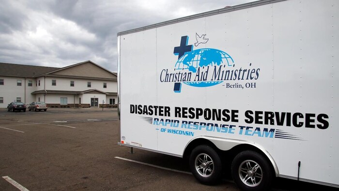 A truck showing the logo of Christian Aid Ministries with "Disaster Response Services - Rapid Response Team of Wisconsin".