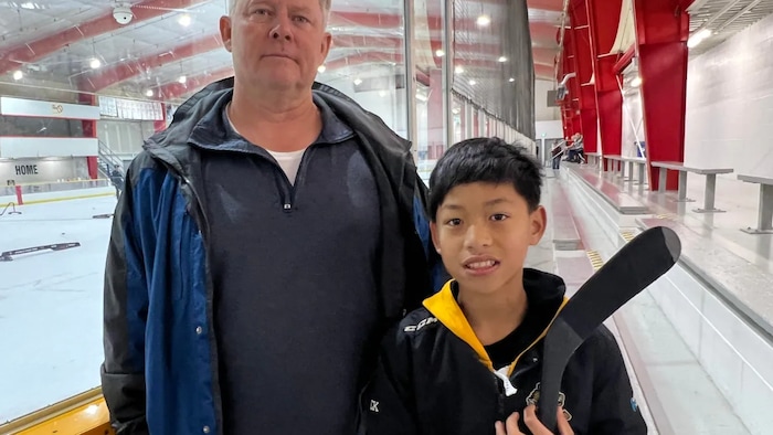 Harry Chadwick's son Harrison was legally adopted from China before he turned two years old, but he needs to get a transfer from his country of birth before he can play in a licensed program in Canada. (Andrew Lupton/CBC News)