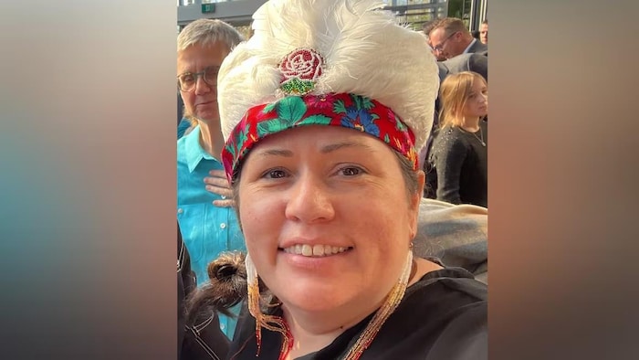La cheffe de la Première Nation crie de Misipawistik, Heidi Cook, portant une coiffe autochtone traditionnelle.