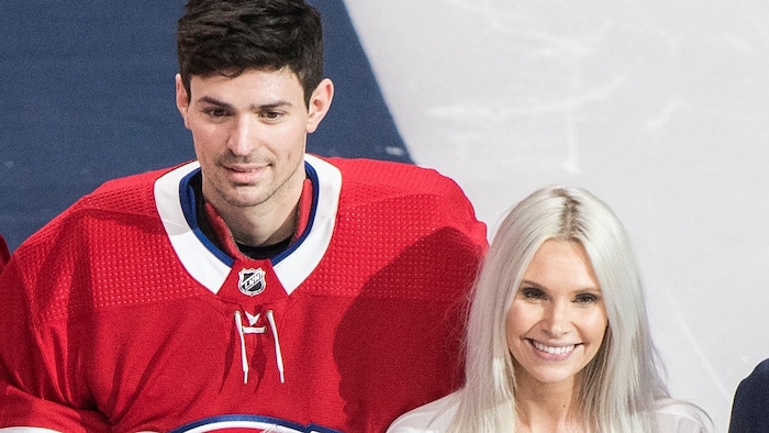 Angela Price, seen here with her husband before a game against the Chicago Blackhawks on March 16, 2019, stressed the importance of putting 'mental health first.'