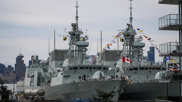 A crew member drops a bag of trash into a bin as HMCS Regina, left, and HMCS Vancouver are seen docked as part of Fleet Week, in North Vancouver, B.C., on Friday, May 3, 2024. THE CANADIAN PRESS/Darryl Dyck