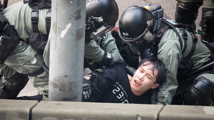 Hong Kong police arrest a young protester in September 2019 after one of many street confrontations that grew in intensity that year and became the justification for Beijing to impose the national security law in the territory. (Saša Petricic/CBC)