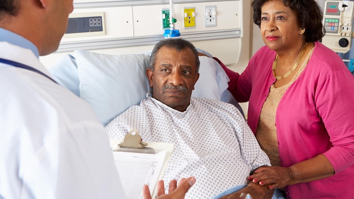 Un médecin fait part d'informations à son patient hospitalisé.