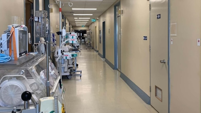 Un corridor d'hôpital avec toutes sortes d'appareils et d'équipements près du mur.