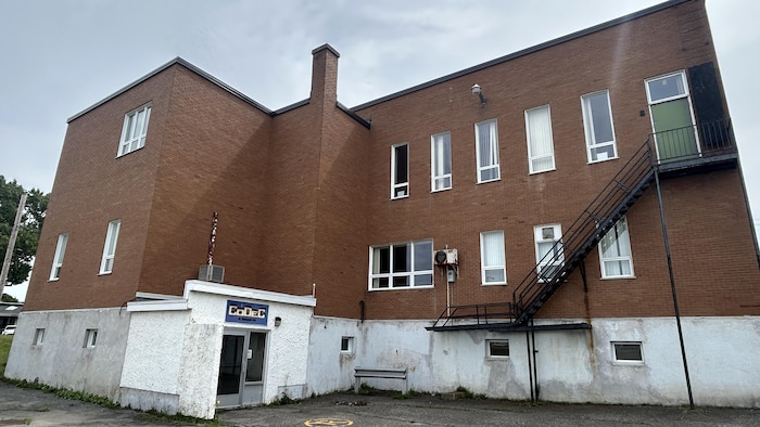 La cheminée se trouve à l'arrière du bâtiment en briques rouges.