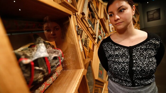Julia Peristerakis, acting researcher and curator for indigenous content at the Canadian Museum for Human Rights in Winnipeg, looks at a shoe found at Carcross Residential School which is part of a new exhibit called The Witness Blanket that opened on the eve of the release of the final report by the Truth and Reconciliation Commission. The exhibition runs until the end of June 2016.