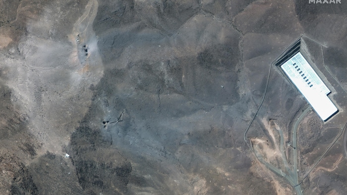 This satellite image provided by Maxar Technologies shows a close view of craters on a crest of the Fordo enrichment factory in Iran after the American strikes.