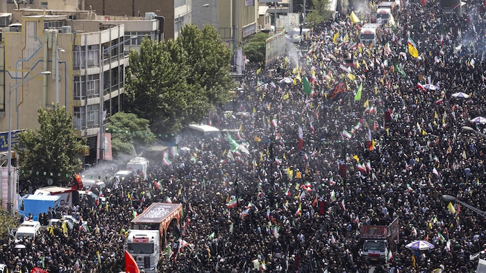 A crowd in the street. national funeral iran high officers