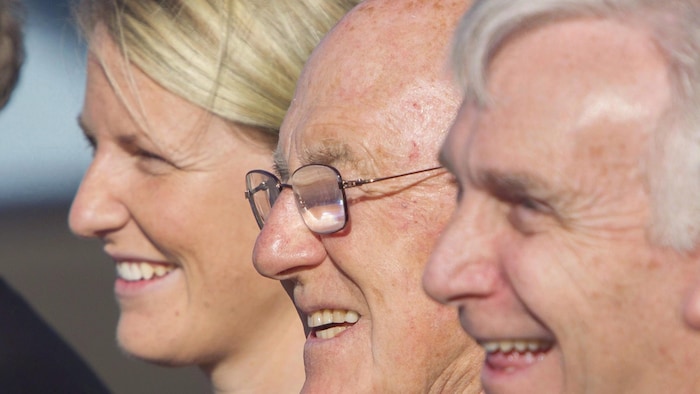 The faces of the three leaders standing in a row.