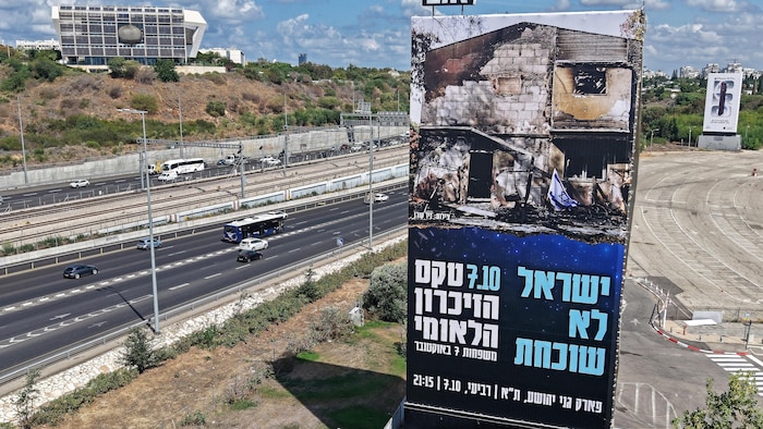 Une bannière publicitaire marquant le troisième anniversaire des attaques du Hamas installée au bord d'une autoroute à Tel-Aviv sur laquelle on peut lire en hébreu: « Israël n'oublie jamais ».