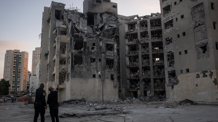 Police officers examine a building where four people were killed by an Iranian missile shot on June 24, 2025 in Beersheba, Israel.