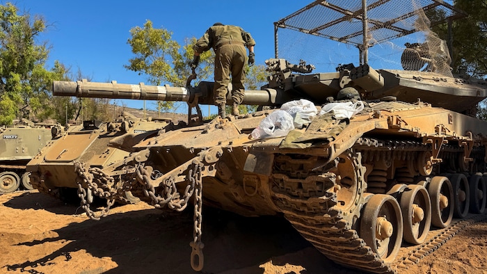 Un soldat israélien s'affaire autour d'un char du côté israélien.