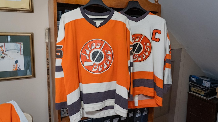 Deux gilets de hockey orange, brun et blanc.