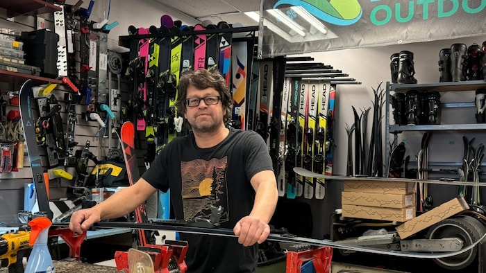 Jean-François Bussières dans son magasin, Pure Outdoors, avec une paire de skis. 