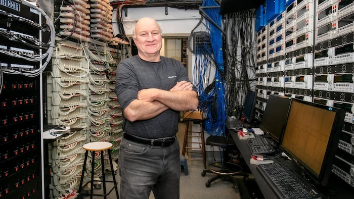 The physicist stands in front of rows of machines and threads. battery electric bike originally fire