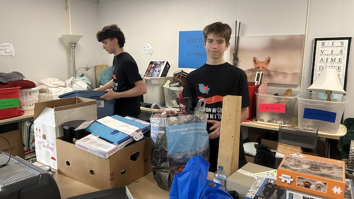 Des jeunes qui trient des items sur une table.