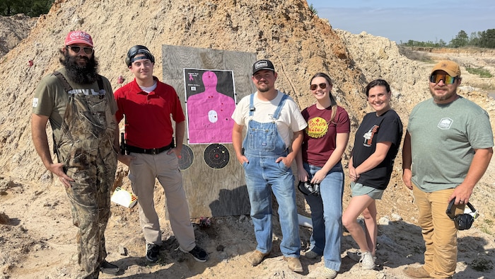 Texas young Republicans posing in front of a target.