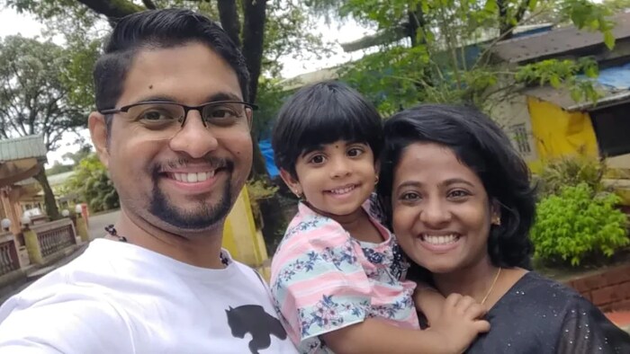 Jibi Mathews, right, poses with her husband and daughter. Mathews has been waiting for more than two years on her permanent residency application. 