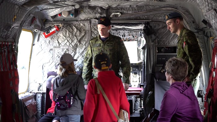 Des personnes à l'intérieur d'un hélicoptère de combat de l'Aviation royale canadienne.