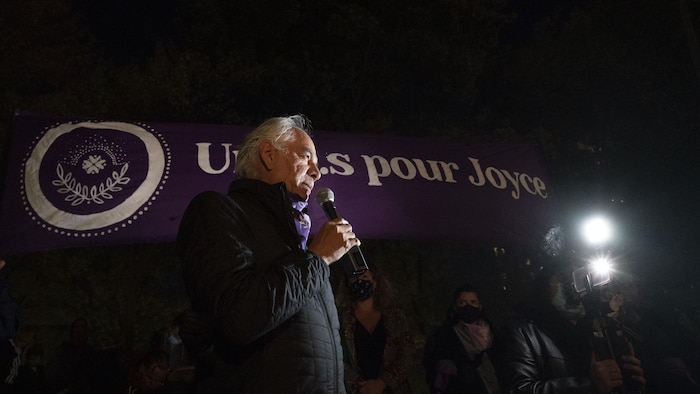 Un homme debout avec l'inscription en arrière Uni.e.s pour Joyce