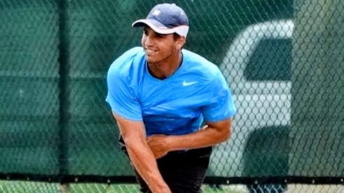 Justin Bourassa jouant au tennis. 