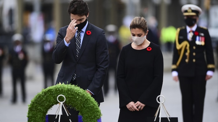 رئيس الحكومة الكندية جوستان ترودو وزوجته صوفي غريغوار ينحنيان أمام النصب التذكاري للحرب الذي يكرّم الجنود الكنديين الذين سقطوا في ساحات الشرف، في يوم الذكرى في أوتاوا في 11 تشرين الثاني (نوفمبر) 2020.