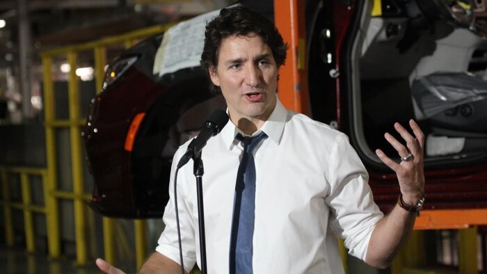 Justin Trudeau speaks in a microphone.