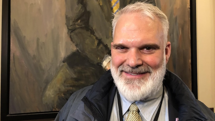 Kevin Haché sourit devant un cadre d'époque, le jour du dépôt du budget de Blaine Higgs, le 10 mars 2020.