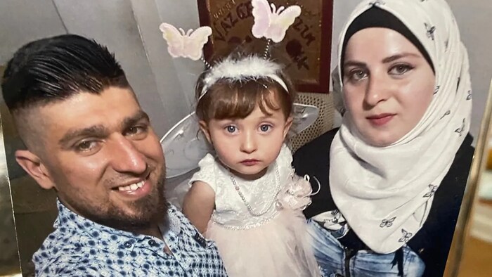 Adnan Kharsa treasures this photograph of his parents, Mohammed Kharsa and Yasmine Sheikho, and his little sister, Sham, together in Turkey. He has only met his sister over video chat. (Bonnie Allen/CBC )