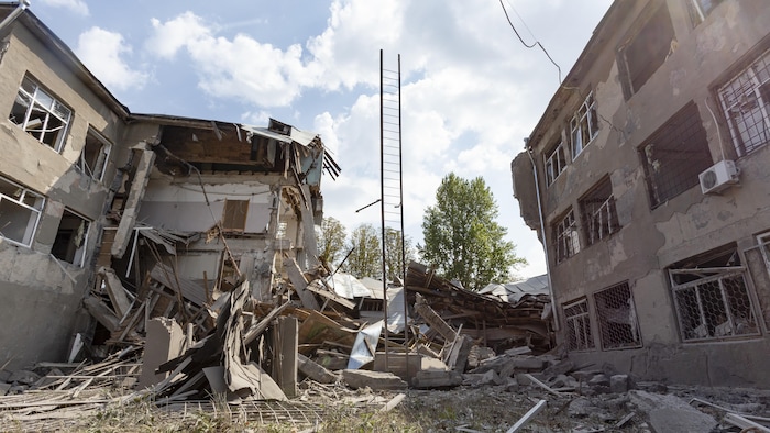 Le laboratoire est en ruines, mais une échelle tient à la verticale au milieu des décombres.