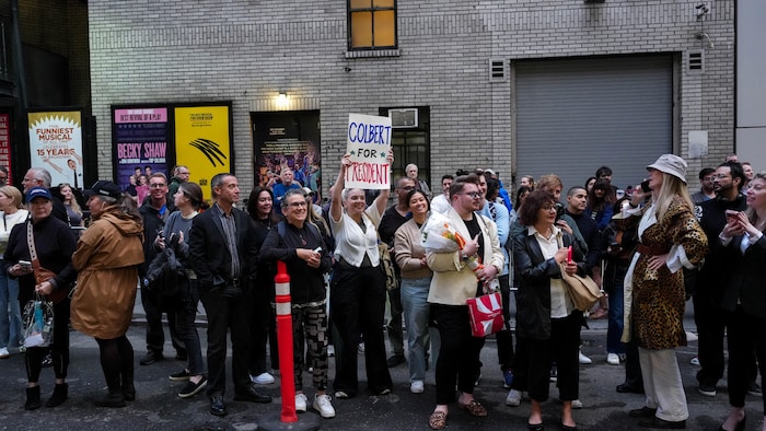 Une foule attend devant l'Ed Sullivan Theater, où est enregistrée la dernière émission du « Late Show » de Stephen Colbert, à New York, le 21 mai 2026. 