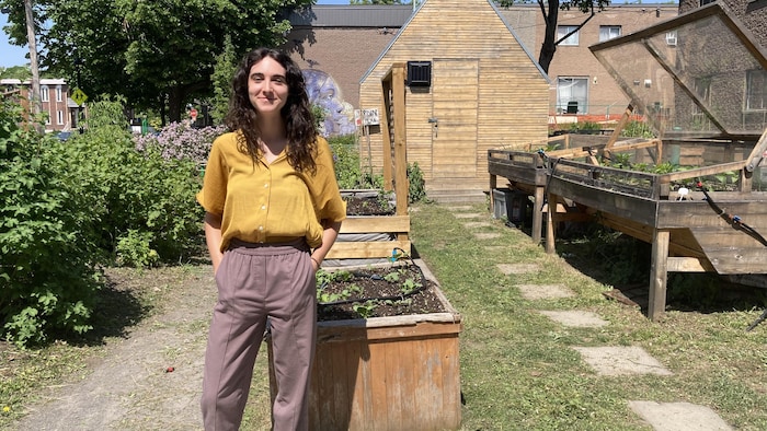 Worker responsible for mobilizing citizens for the Harmony Project, Laurie Hito in front of the community garden at HLM La Pépinière.