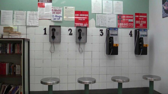 Phones and payphones and legal aid posters.