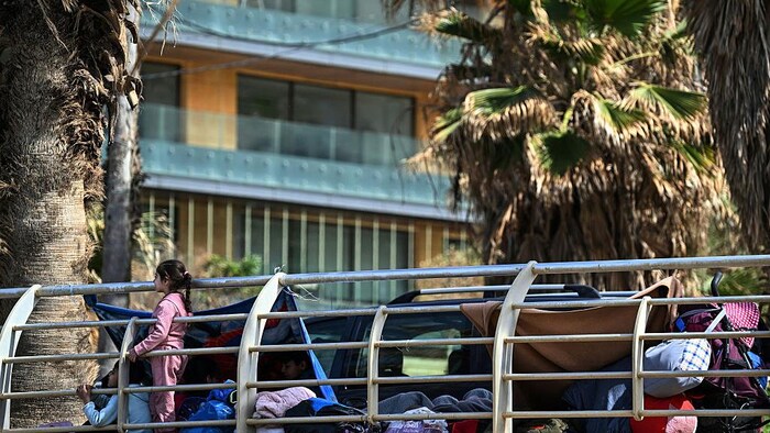 Un enfant regarde au-dessus de la balustrade de l'abri.