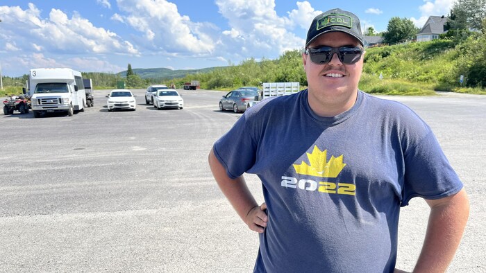 Un homme sourit à la caméra.