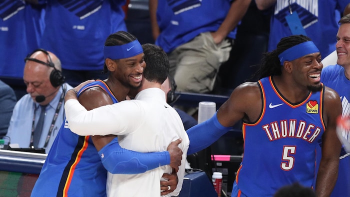 Shai Gilgeous Alexander in the arms of his coach. sga, hamilton best player nba